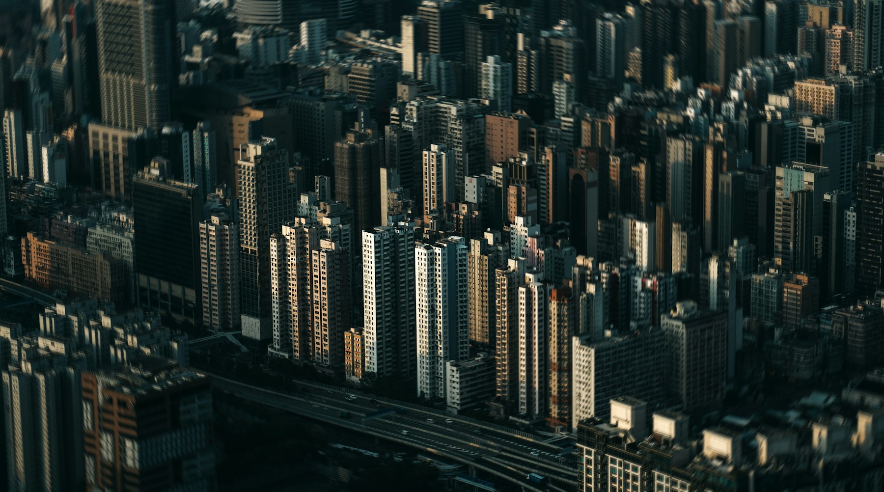 A dense aerial view of a city skyline at dusk.