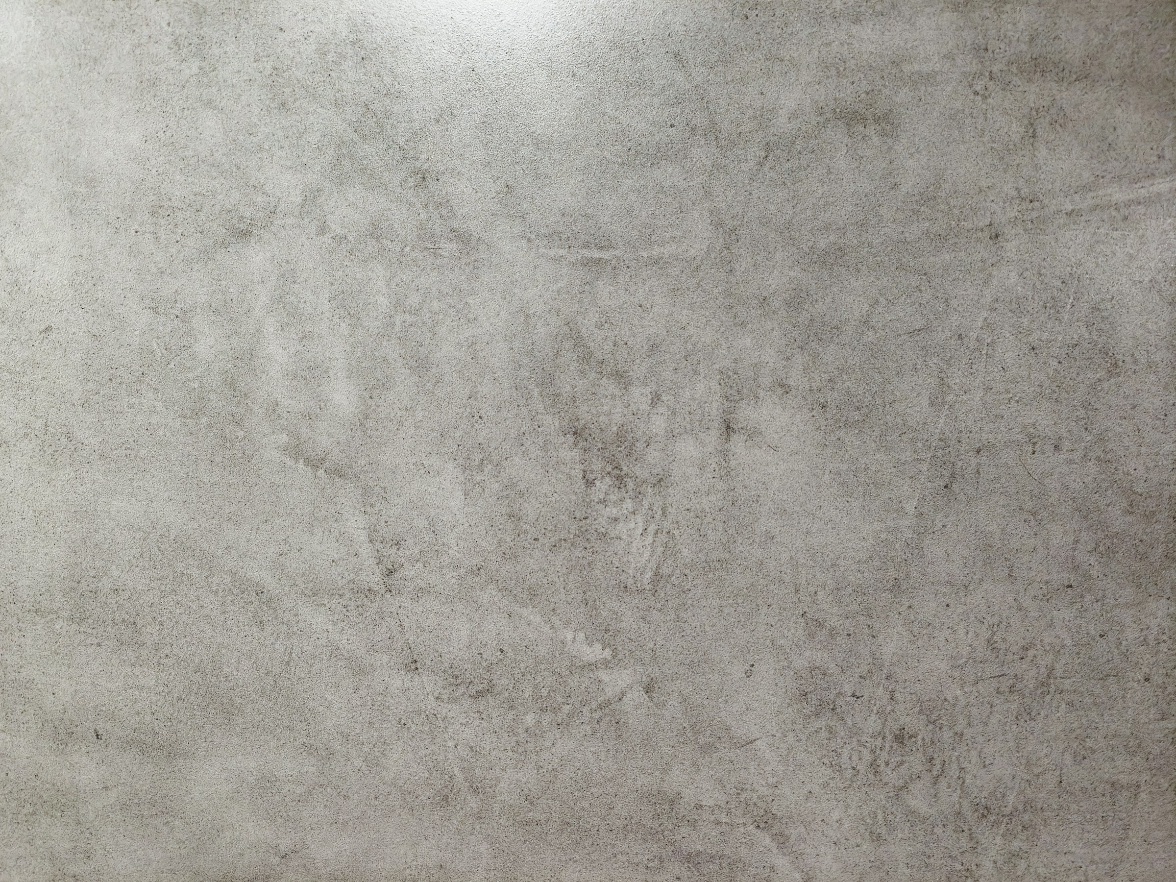 Textured grey concrete surface, evoking structural business foundations.